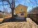Fenced-in backyard featuring a large shade tree and patio at 1090 Ohara Dr, Jonesboro, GA 30236