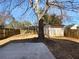 Spacious backyard with mature tree, storage shed, and partially fenced perimeter at 1090 Ohara Dr, Jonesboro, GA 30236