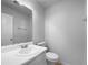 Compact half-bathroom featuring a clean white vanity, large mirror, and standard toilet at 1090 Ohara Dr, Jonesboro, GA 30236