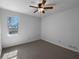 Neutral bedroom with carpet, window with view and ceiling fan with light fixture at 1090 Ohara Dr, Jonesboro, GA 30236