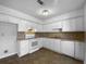 Efficient kitchen design with white cabinets, appliances, and tile flooring at 1090 Ohara Dr, Jonesboro, GA 30236