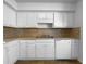 Kitchen showcasing white cabinets, neutral countertops, stainless steel sink and dishwasher at 1090 Ohara Dr, Jonesboro, GA 30236