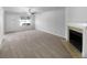 Spacious living room with fireplace, large window, and neutral carpet at 1090 Ohara Dr, Jonesboro, GA 30236