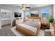Stylishly staged main bedroom with large windows, ensuite bathroom, and modern decor at 1090 Ohara Dr, Jonesboro, GA 30236