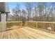 Large wooden back deck with railing overlooks private backyard, a great outdoor space for a Gathering at 161 Kingswood Dr, Ellenwood, GA 30294