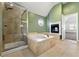 Bathroom featuring a separate shower, soaking tub, built-in fireplace, and green colored walls at 3744 Misty Wood Nw Dr, Marietta, GA 30064
