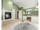 Bathroom boasting a garden tub, fireplace, double vanity with granite countertops, and green walls at 3744 Misty Wood Nw Dr, Marietta, GA 30064