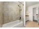 Tiled bathroom featuring a tub with shower head, and a granite-topped vanity at 3744 Misty Wood Nw Dr, Marietta, GA 30064