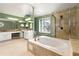 Well-lit bathroom showcasing a soaking tub, glass shower, granite counters, and neutral tile at 3744 Misty Wood Nw Dr, Marietta, GA 30064