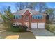 Two-story brick home featuring a two-car garage and traditional architectural details at 3744 Misty Wood Nw Dr, Marietta, GA 30064