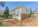 An exterior view of a house, featuring white siding, brick foundation, and backyard patio at 3744 Misty Wood Nw Dr, Marietta, GA 30064
