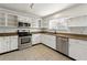 Well-lit kitchen features stainless steel appliances, granite countertops, and white cabinets at 3744 Misty Wood Nw Dr, Marietta, GA 30064