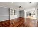 Open-concept living room featuring hardwood floors, built-in shelving, and adjacent kitchen at 3744 Misty Wood Nw Dr, Marietta, GA 30064