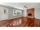 Cozy living room with a brick fireplace, hardwood floors, and natural light at 3744 Misty Wood Nw Dr, Marietta, GA 30064