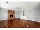 Living room with brick fireplace, hardwood floors, and built-in shelving at 3744 Misty Wood Nw Dr, Marietta, GA 30064