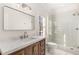 Bright bathroom with large mirror, glass enclosed shower, and marble countertop at 774 Piedmont Ne Ave # 1B, Atlanta, GA 30308