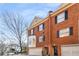 Attractive three-story brick townhome with black shutters and dormer windows at 774 Piedmont Ne Ave # 1B, Atlanta, GA 30308