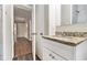 Bathroom with granite countertop vanity, white cabinets and a view to hallway at 1145 Canal St, Decatur, GA 30032