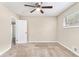 Bright bedroom with a ceiling fan, window, and neutral carpeting offers a comfortable living space at 1145 Canal St, Decatur, GA 30032