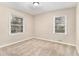 Inviting bedroom with neutral paint, carpeting, and natural light from two windows at 1145 Canal St, Decatur, GA 30032