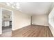 Open-concept layout showcasing wood floors, a view of the kitchen, and a modern chandelier at 1145 Canal St, Decatur, GA 30032