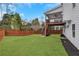 Lush green backyard with elevated deck and staircase, perfect for outdoor entertaining and relaxation at 2383 Colonial Ne Dr, Brookhaven, GA 30319