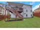 Well-manicured backyard features a deck with stairs, providing a serene outdoor space at 2383 Colonial Ne Dr, Brookhaven, GA 30319