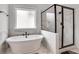 Beautiful bathroom featuring a modern soaking tub and a glass-enclosed shower at 2383 Colonial Ne Dr, Brookhaven, GA 30319