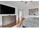 Well lit bedroom featuring hardwood floors, a dresser, and a tv at 2383 Colonial Ne Dr, Brookhaven, GA 30319