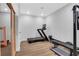 Bright exercise room with new treadmill and fitness equipment on wood floors at 2383 Colonial Ne Dr, Brookhaven, GA 30319