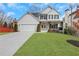 Charming two-story home with a manicured lawn, a two-car garage, and a welcoming front porch at 2383 Colonial Ne Dr, Brookhaven, GA 30319