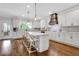 Bright kitchen with white cabinets, an island with seating, and hardwood flooring at 2383 Colonial Ne Dr, Brookhaven, GA 30319