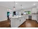 Open kitchen with white cabinets, hardwood floors, and a view to the living room at 2383 Colonial Ne Dr, Brookhaven, GA 30319