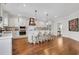 Bright kitchen with white cabinets, an island with seating, and hardwood flooring at 2383 Colonial Ne Dr, Brookhaven, GA 30319