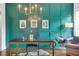 Well-lit office featuring a teal accent wall, hardwood floors, and a modern chandelier at 2383 Colonial Ne Dr, Brookhaven, GA 30319