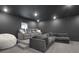 Home theater room with plush seating, a tiered platform, and neutral colors at 2383 Colonial Ne Dr, Brookhaven, GA 30319