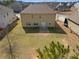 Backyard view highlighting spacious lawn, the house's rear facade, and neighborhood at 2592 Jacanar Sw Ln, Atlanta, GA 30331