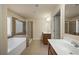 A spacious bathroom featuring a double vanity, shower, and soaking tub at 2592 Jacanar Sw Ln, Atlanta, GA 30331