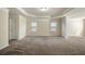 Spacious carpeted bedroom with crown molding and natural light from two windows at 2592 Jacanar Sw Ln, Atlanta, GA 30331