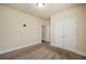 Neutral bedroom featuring plush carpet, a ceiling light, and a double-door closet at 2592 Jacanar Sw Ln, Atlanta, GA 30331