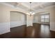 Large dining room with coffered ceiling, hardwood floors, and elegant chandelier at 2592 Jacanar Sw Ln, Atlanta, GA 30331