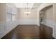 Elegant dining area featuring hardwood floors, wainscoting, coffered ceiling, and stylish chandelier at 2592 Jacanar Sw Ln, Atlanta, GA 30331