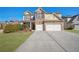 Charming two-story home featuring a brick facade, a two-car garage, and a well-manicured front yard at 2592 Jacanar Sw Ln, Atlanta, GA 30331