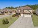 Aerial view showcasing this home's lush landscaping, spacious driveway, and two-car garage nestled in a neighborhood at 2592 Jacanar Sw Ln, Atlanta, GA 30331