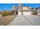 Charming two-story home featuring a brick facade, a two-car garage, and a well-manicured front yard at 2592 Jacanar Sw Ln, Atlanta, GA 30331