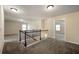 Hallway with carpet, a wooden railing, and access to the rooms and a lot of natural light at 2592 Jacanar Sw Ln, Atlanta, GA 30331