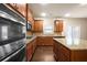 Modern kitchen featuring granite countertops, dark wood cabinetry, and stainless steel appliances at 2592 Jacanar Sw Ln, Atlanta, GA 30331