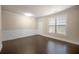 Versatile living space features hardwood floors, wainscoting, and a bright window at 2592 Jacanar Sw Ln, Atlanta, GA 30331