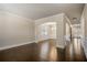 Bright living room with dark hardwood floors, arched doorway, wainscotting and white trim at 2592 Jacanar Sw Ln, Atlanta, GA 30331