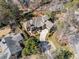 An aerial view displays a stately brick home nestled within a lush, wooded landscape at 3979 Sentry Xing, Marietta, GA 30068